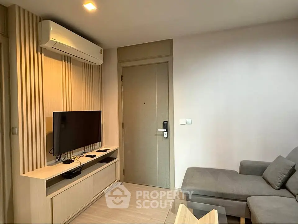 Modern living room with sleek furniture and wall-mounted TV, perfect for cozy relaxation.