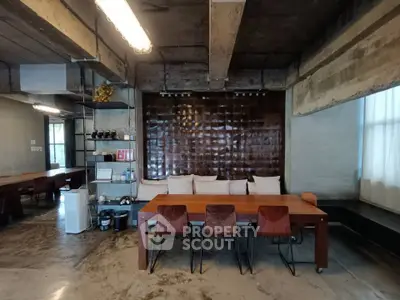 Stylish industrial-style living room with concrete walls and wooden furniture, perfect for modern urban living.