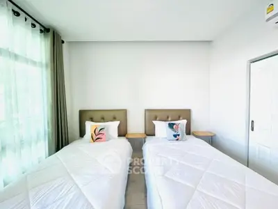 Bright bedroom with twin beds and modern decor in a stylish home.