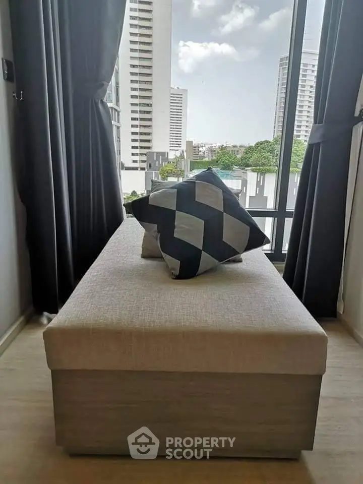 Modern apartment with stylish interior and city view from large window.
