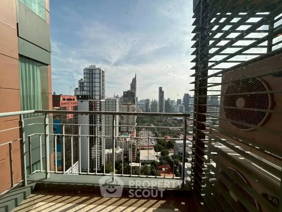 Stunning city view from a high-rise balcony with modern architectural elements.