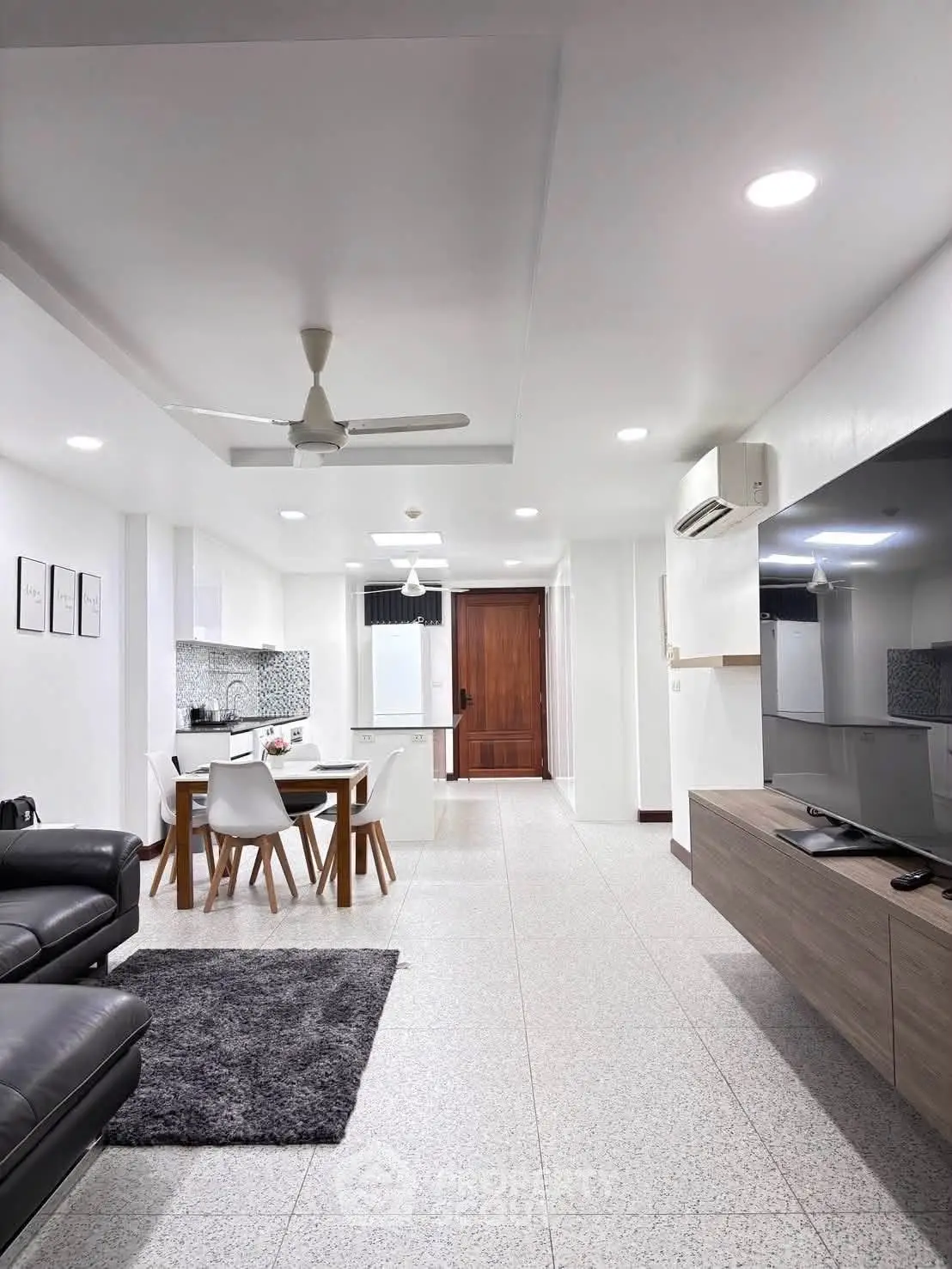 Modern open-plan living room with sleek kitchen and stylish decor