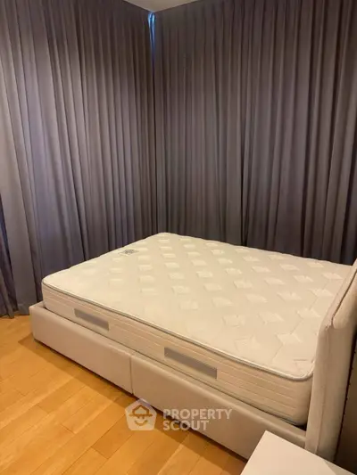 Spacious bedroom with elegant curtains and a comfortable bed, perfect for relaxation.
