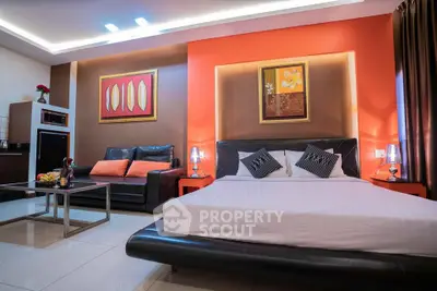 Luxurious modern bedroom with stylish decor and cozy seating area.