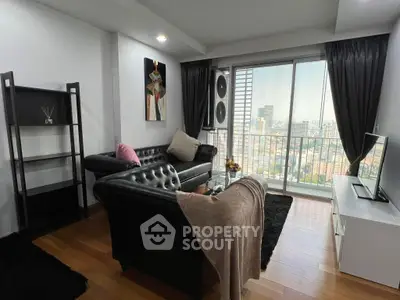 Stylish living room with city view, modern furniture, and hardwood floors in high-rise apartment.