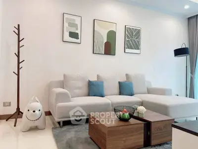 Modern living room with stylish decor, cozy sofa, and elegant wall art in a bright, inviting space.