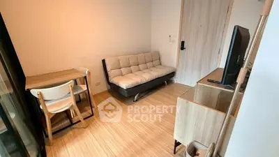 Cozy modern living room with sofa, TV, and wooden flooring