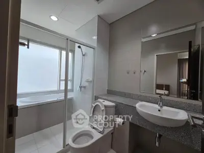 Modern bathroom with bathtub and sleek fixtures in a contemporary home.