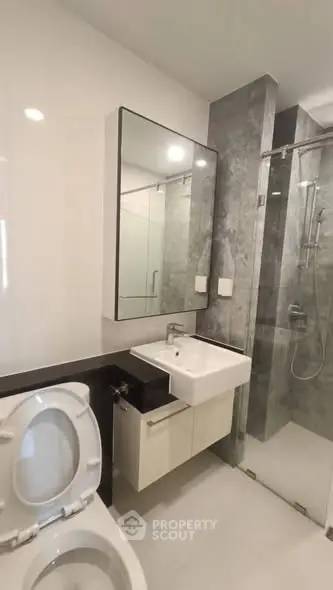 Modern bathroom with sleek fixtures and glass shower enclosure