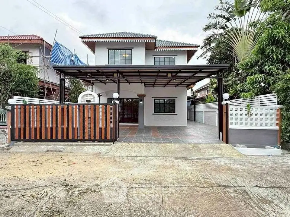 Charming two-story house with spacious driveway and modern exterior design.
