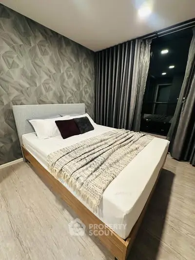 Modern bedroom with stylish decor and cozy ambiance, featuring a comfortable bed and elegant wallpaper.
