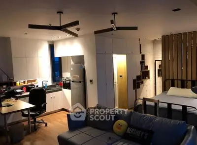 Modern studio apartment with open layout, featuring a cozy living area, workspace, and stylish kitchen.