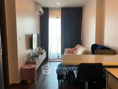 Modern living room with stylish furniture and natural light from large window.