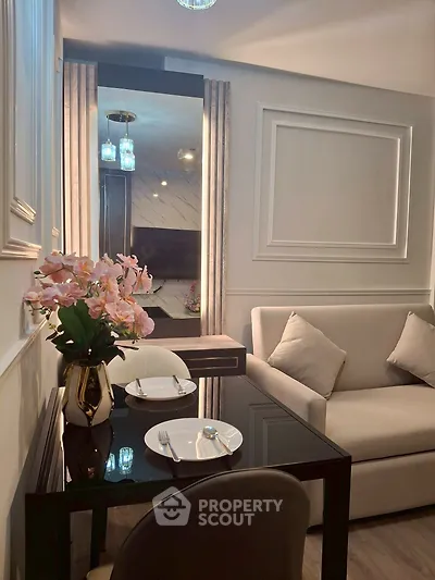Elegant living room with modern decor, cozy sofa, and stylish dining area in a chic apartment.