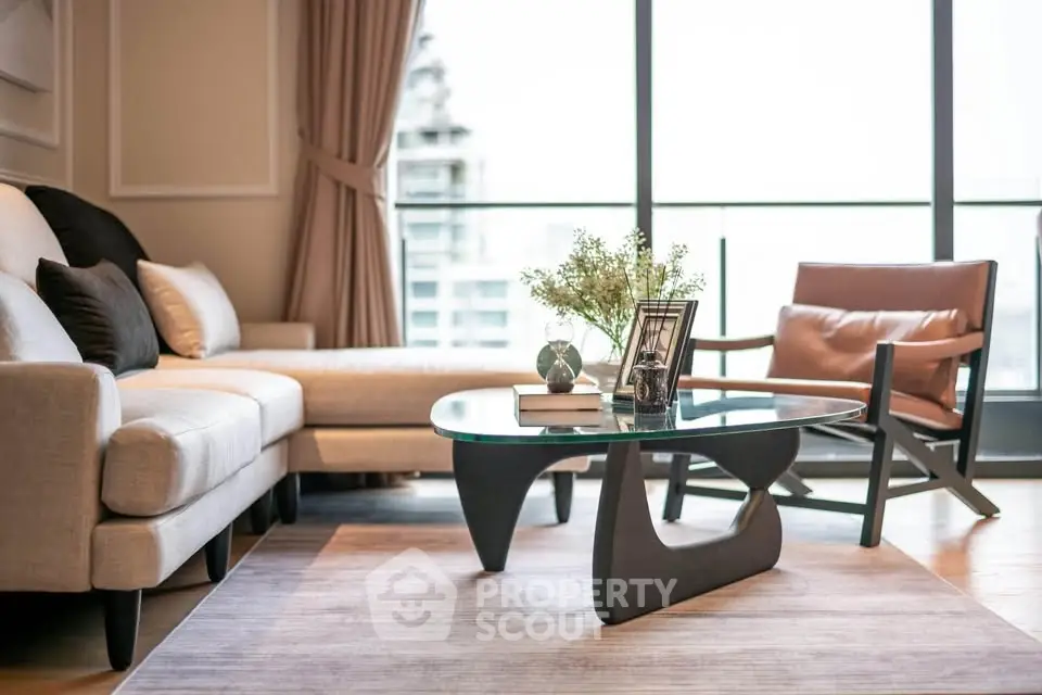 Elegant living room with modern furniture and large windows offering a stunning city view.