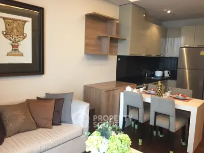 Modern open-layout kitchen and living area with stylish decor and dining set.