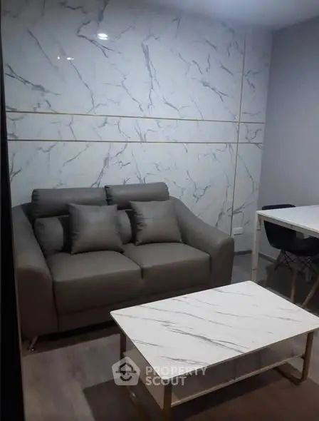 Modern living room with marble accent wall and stylish furniture