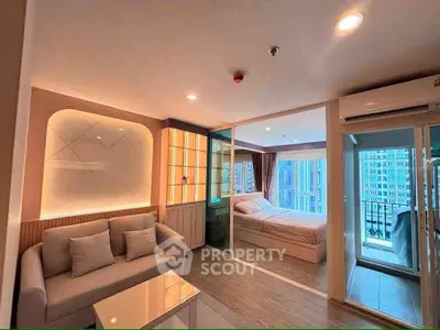 Modern condo interior with cozy living room and glass-walled bedroom, featuring a balcony view.