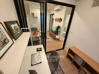 Modern apartment interior with study area and cozy living room, featuring sleek furniture and stylish decor.