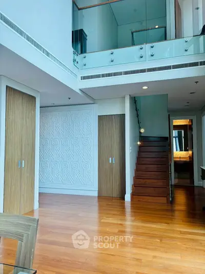 Luxurious modern duplex with wooden floors and stylish staircase, perfect for upscale living.