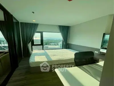 Modern bedroom with large window offering scenic view and natural light