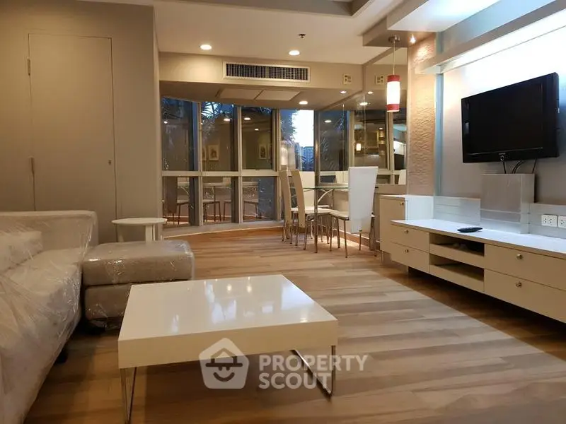 Modern living room with stylish furniture and large windows offering natural light.