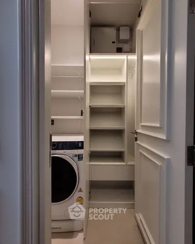 Modern laundry room with built-in storage and Electrolux washing machine