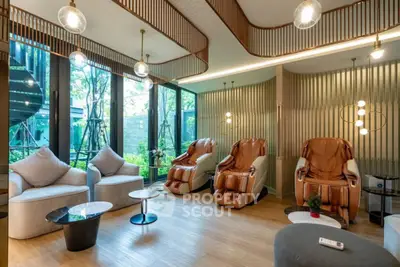 Luxurious modern living room with massage chairs and large windows overlooking greenery