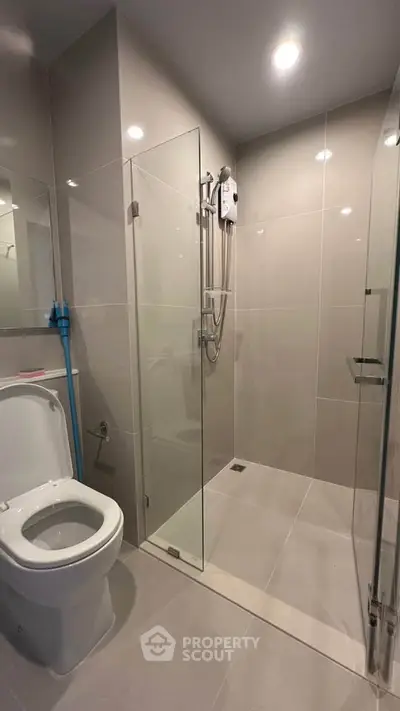 Modern bathroom with glass shower enclosure and sleek fixtures