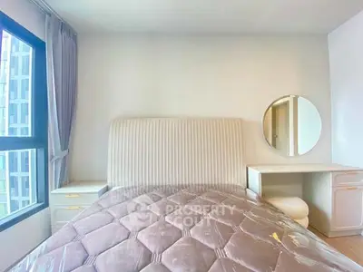 Bright bedroom with modern furniture and large window view