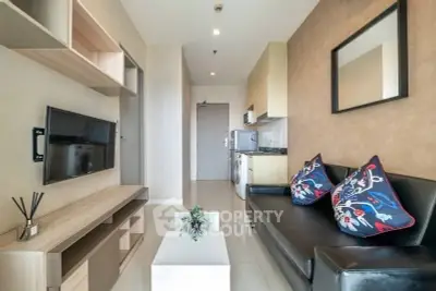 Modern living room with sleek furniture and wall-mounted TV in stylish apartment.
