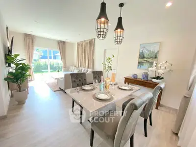 Elegant open-plan living and dining area with modern decor and natural light.