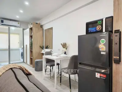 Modern apartment interior with dining area and kitchen appliances