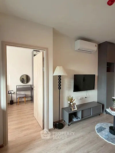 Modern living room with stylish decor and open view to adjacent room