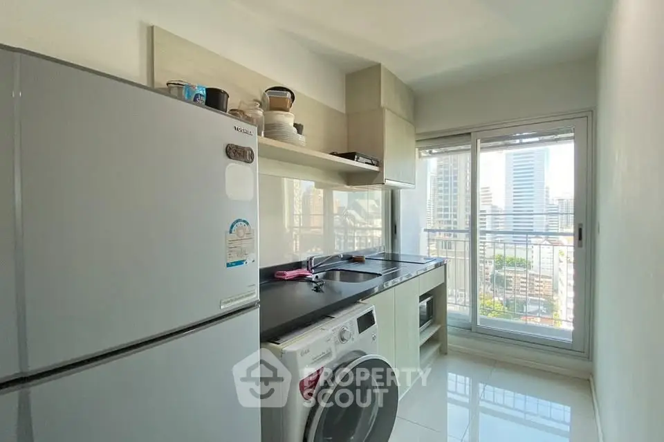Modern kitchen with city view, featuring sleek appliances and ample natural light.
