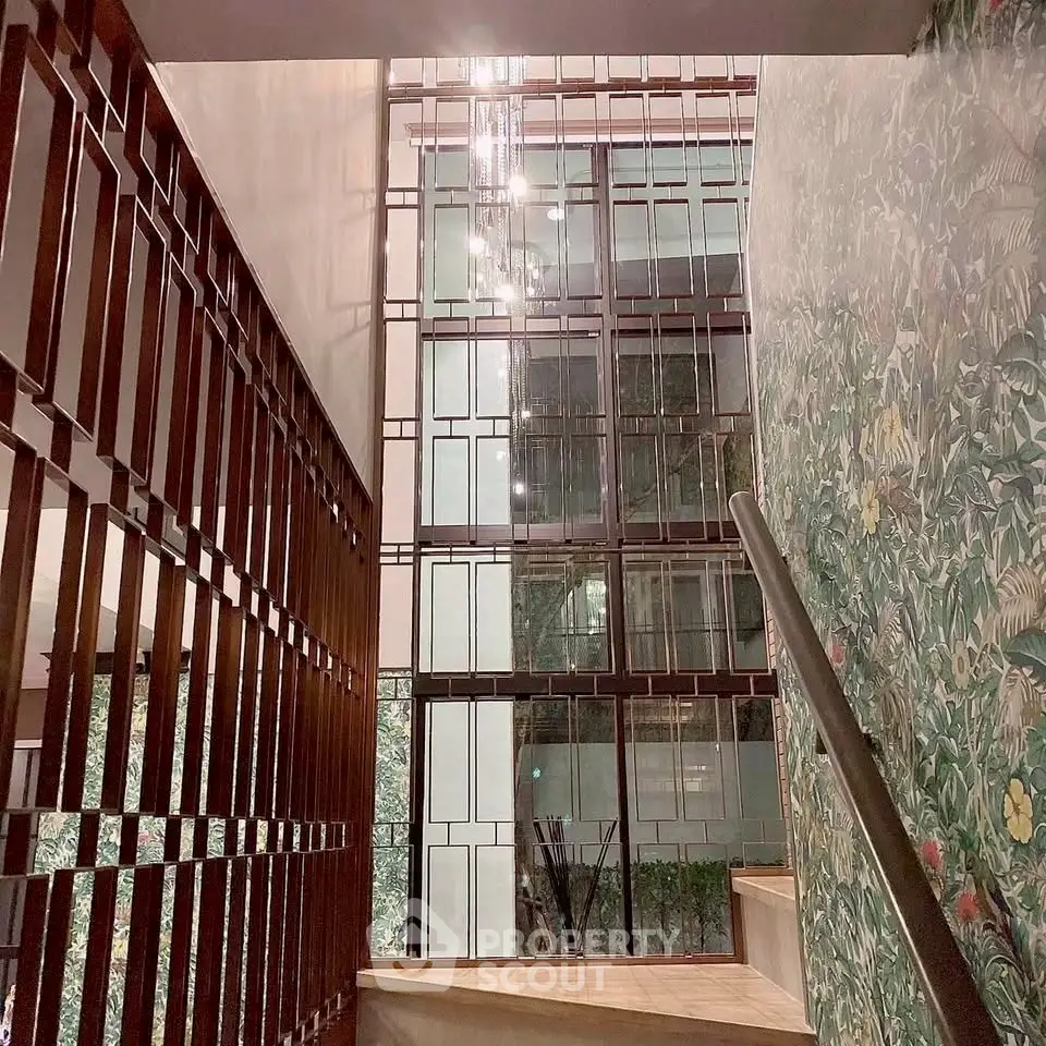 Elegant staircase with modern design and artistic wall decor in luxury building