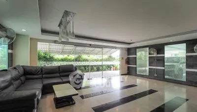 Spacious modern living room with sleek design and large windows for natural light.