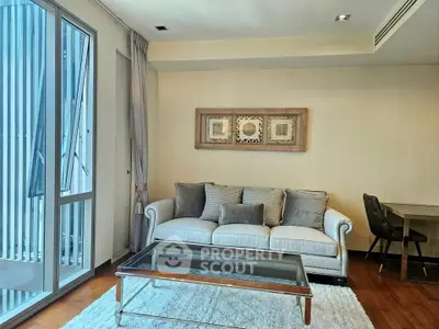 Elegant living room with modern decor and large windows in a stylish apartment.
