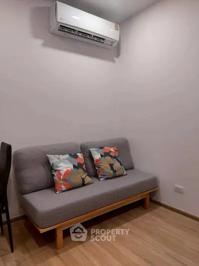 Cozy living room corner with modern sofa and air conditioning