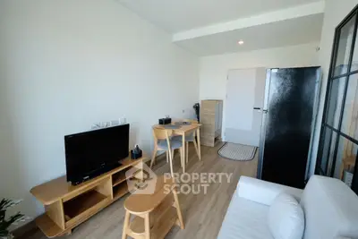 Modern living room with sleek furniture and wooden flooring in a cozy apartment.