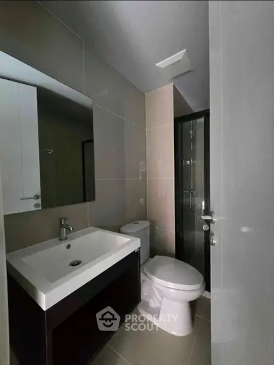 Modern bathroom with sleek fixtures and glass shower enclosure