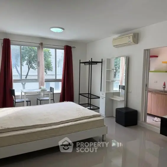 Spacious modern bedroom with large windows and minimalist decor