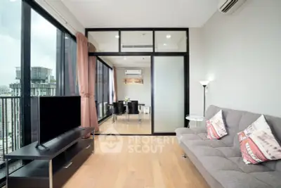 Modern living room with city view, featuring sleek furniture and large windows for natural light.
