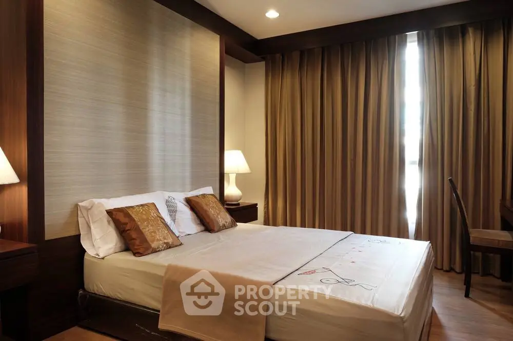 Elegant bedroom with cozy lighting and stylish decor, featuring a comfortable bed and warm ambiance.