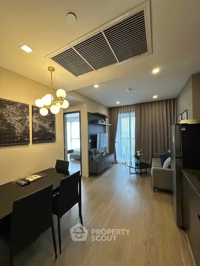 Modern open-plan living room with dining area and stylish decor