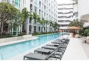 Luxurious apartment complex with a stunning outdoor pool and modern design.