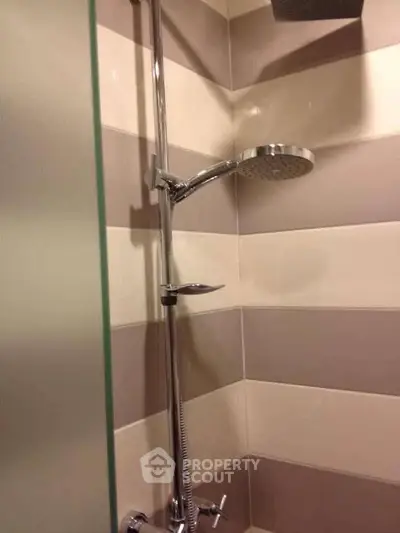 Modern bathroom shower with sleek chrome fixtures and stylish tile design.