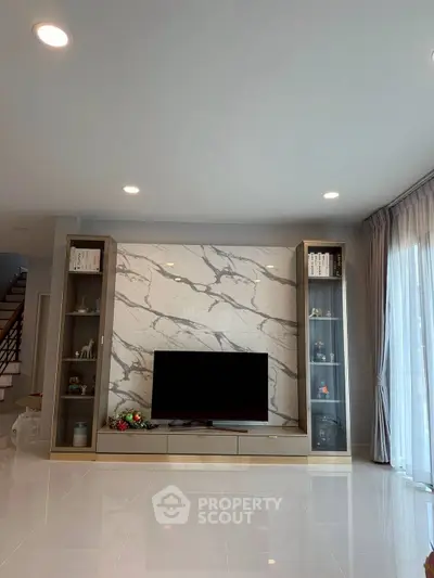Modern living room with marble accent wall and sleek TV setup