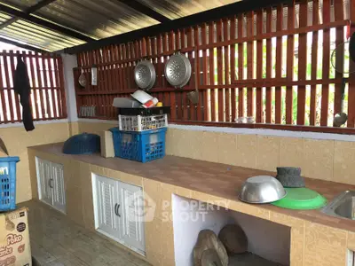 Spacious outdoor kitchen with ample counter space and storage, perfect for culinary enthusiasts.