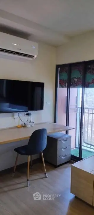 Modern study room with balcony access and sleek furniture